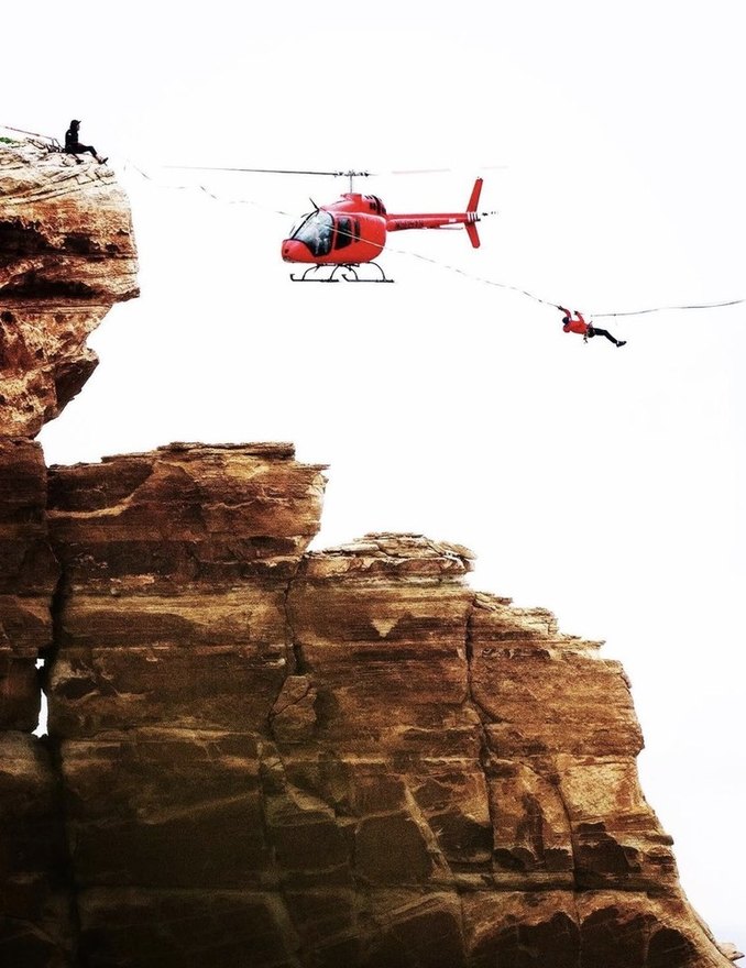 Aerial film shoot from a helicopter over a sea cliff