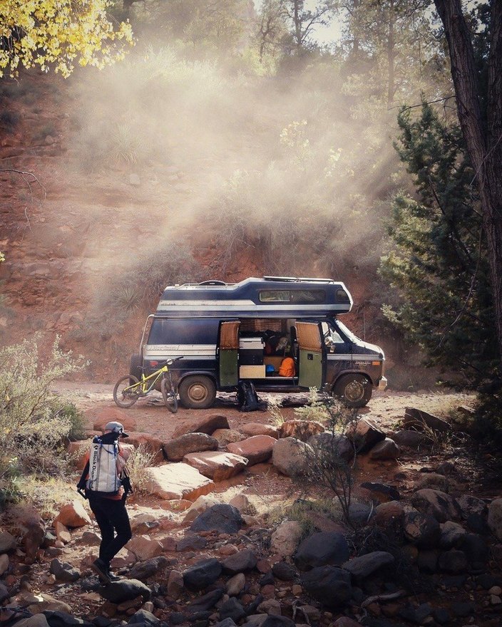 Adventure van and mountain bike in a desert canyon